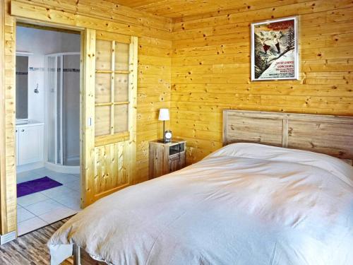 a bedroom with a bed in a log cabin at Chalet Le Corbier, 8 pièces, 16 personnes - FR-1-267-257 in Villarembert