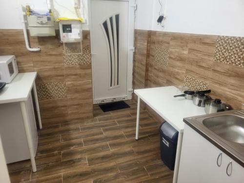 a kitchen with a sink and a refrigerator at Sleepover City Center Apartment in Budapest