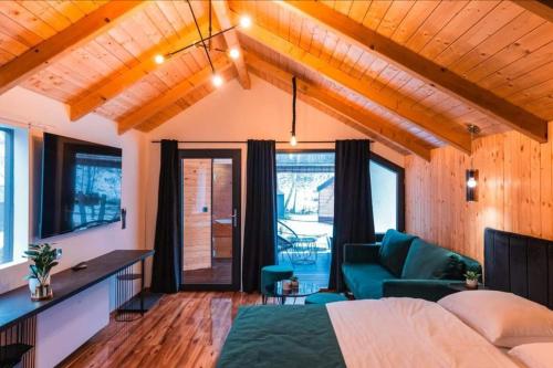 a bedroom with a bed and a couch at Glamping Resort Halicanum in Sveti Martin na Muri