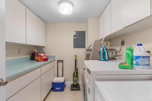 a kitchen with white cabinets and a white sink at RIVERFRONT VIEW, Stunning Sunrises, Community Pool - Condo Waterfront Sunrise - Roelens in Cape Coral