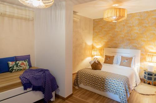 a bedroom with a bed and a table at Portas da Cidade Home in Silves