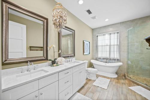 a bathroom with a tub and a sink and a toilet at Southern Exposure AMV in Anna Maria