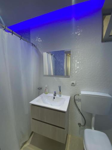 a white bathroom with a sink and a toilet at Sea View Big Lanche in Praia Baixo