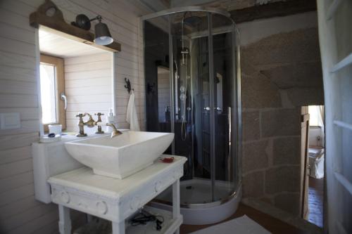 a white bathroom with a sink and a shower at Logis de Riparfonds in Bressuire
