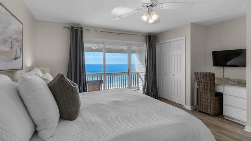 a bedroom with a bed with a view of the ocean at Blue Nine 5 in Panama City Beach