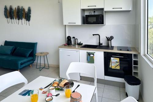 a kitchen with a table with a plate of food on it at Villa Ansalane in Quartiers Anse à lʼÂne