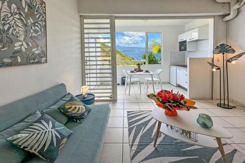 a living room with a couch and a table at Villa Ansalane in Quartiers Anse à lʼÂne