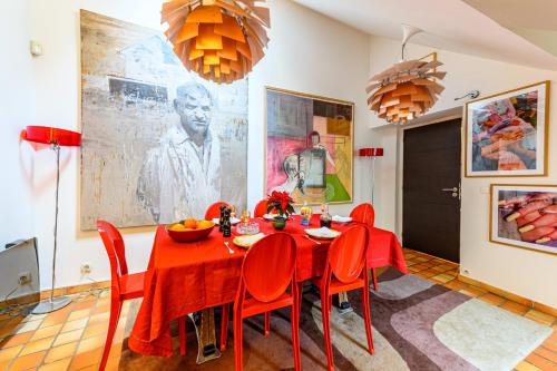 une salle à manger avec une table et des chaises rouges dans l'établissement Appartement Sauval - Welkeys, à Paris
