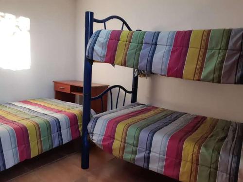 two bunk beds in a room with a table at Hospedaje familiar in Viña del Mar