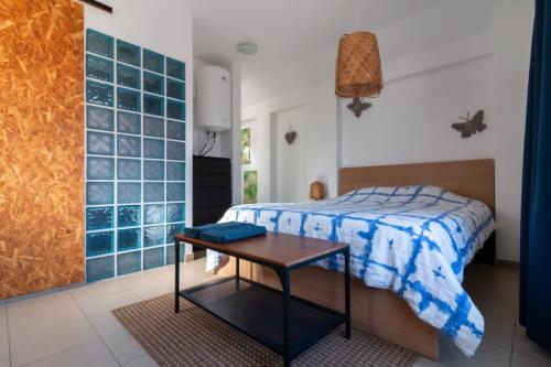 a bedroom with a bed and a table at NewStar Duplex in Setúbal