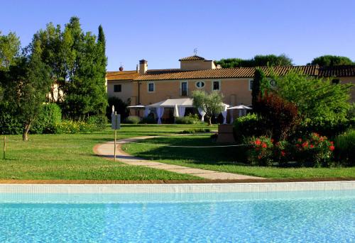 a house and a swimming pool in front of a house at Le Colombaie Country Resort in Ponsacco