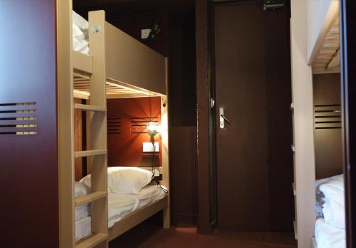 a room with two bunk beds and a hallway at ho36 La Plagne in La Plagne