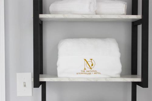 a shelf with a white towel and towels at The National Hotel in Frenchtown