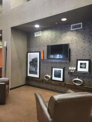 a lobby with a tv and a couch and chairs at Hampton Inn & Suites Austin Cedar Park-Lakeline in Austin