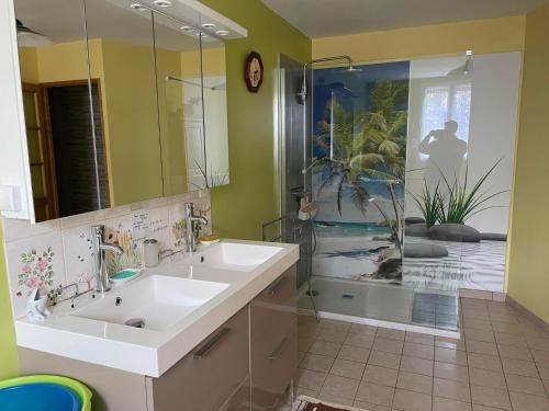 a bathroom with two sinks and a shower at Gîte d'Haute-Cour in Moraches