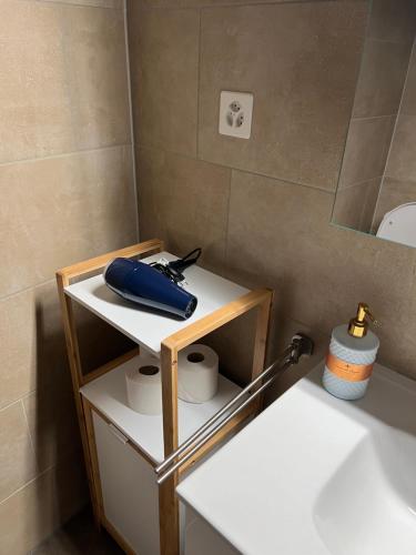 a bathroom with a white shelf next to a sink at Apartment ROSY in Interlaken