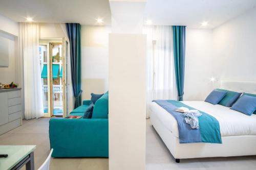 a bedroom with a bed and a couch at SorrentoVibes - Deluxe Apartment in Sorrento Centre in Sorrento