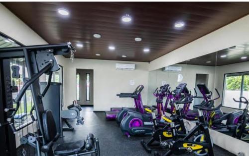 a gym with a bunch of cardio bikes in it at Vacation Homes in Santiago de los Caballeros