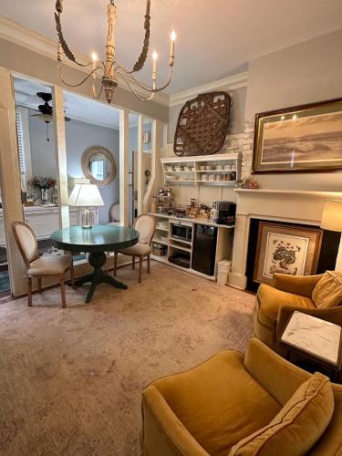 a living room with a table and a fireplace at Bijou Boutique Inn in Charleston