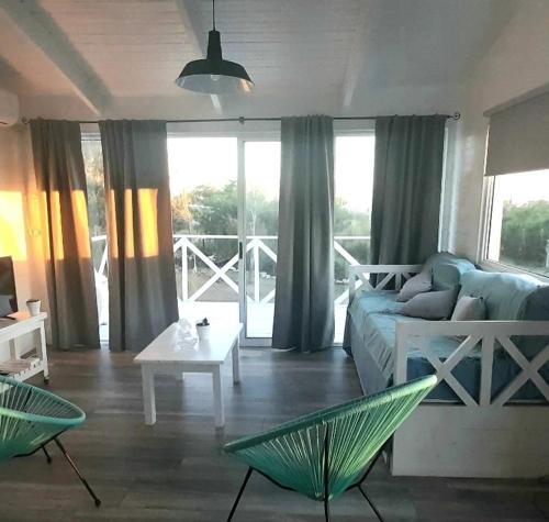 a living room with a couch and a table at Casa Maui in Balneario Buenos Aires