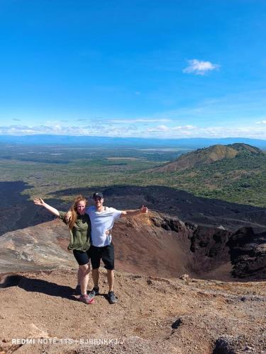 a man and woman standing on top of a mountain at El Callejon Guest House in León