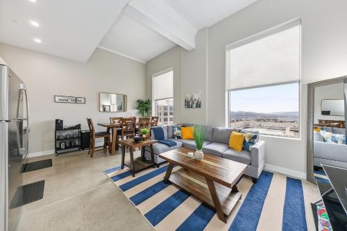 a living room with a couch and a table at King Bed, Downtown Steps from Bengals & Reds, Minutes to OTR, TQL, HardRock in Cincinnati