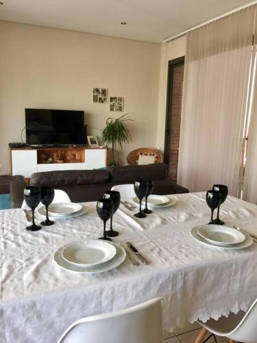 a table with a white table cloth and plates on it at Departament de categoría excelente ubicación in Mendoza