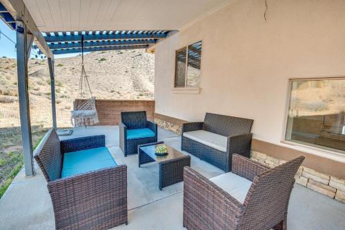 a patio with wicker chairs and a table at Expansive Mountain Gem Game Room, 3 Mi to Acton in Ravenna