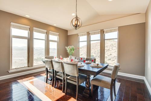 a dining room with a table and chairs and windows at Expansive Mountain Gem Game Room, 3 Mi to Acton in Ravenna