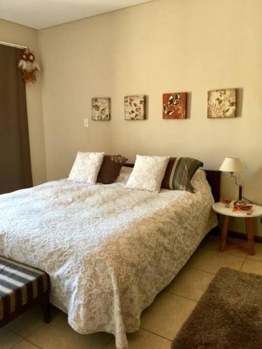a bedroom with a large bed and a table at Departament de categoría excelente ubicación in Mendoza