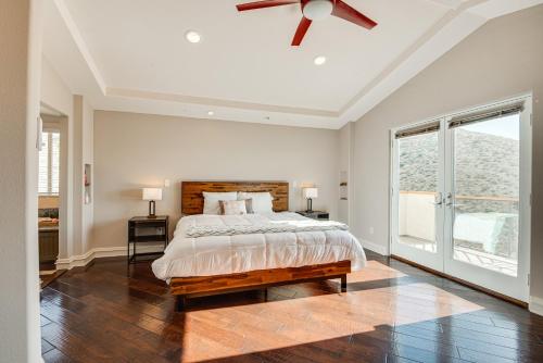 a bedroom with a bed and a ceiling fan at Expansive Mountain Gem Game Room, 3 Mi to Acton in Ravenna