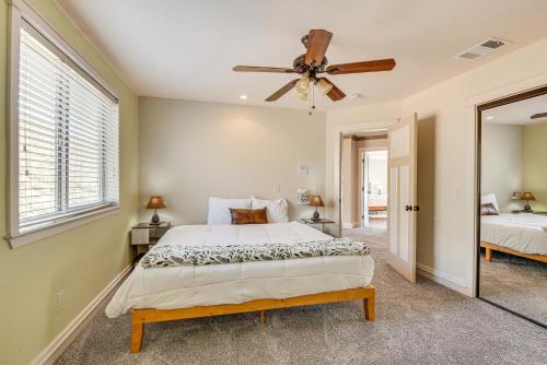 a bedroom with a bed and a ceiling fan at Expansive Mountain Gem Game Room, 3 Mi to Acton in Ravenna