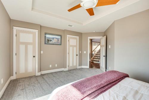 a bedroom with a ceiling fan and a bed at Expansive Mountain Gem Game Room, 3 Mi to Acton in Ravenna