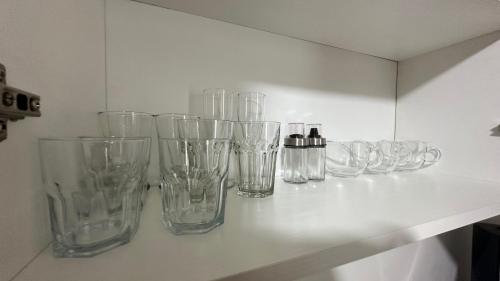 a row of empty glass vases sitting on a shelf at Terra Mia Residence in Mugnano di Napoli
