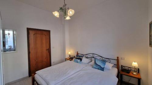a bedroom with a white bed with blue pillows at apartamento "il sole", 2 Balkone, Arbeitsplatz, WIFI in Penne