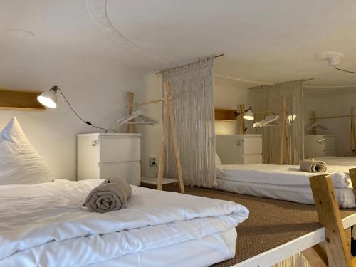 a bedroom with two beds and a refrigerator at Minimal Hostel No 41 in Berlin