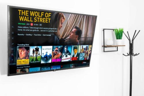 a poster of the wolf of wall street on a wall at Home in Birmingham Cosy Stays in Birmingham