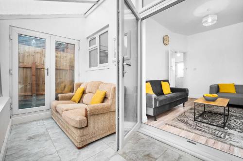 a living room with a couch and a table at Home in Birmingham Cosy Stays in Birmingham