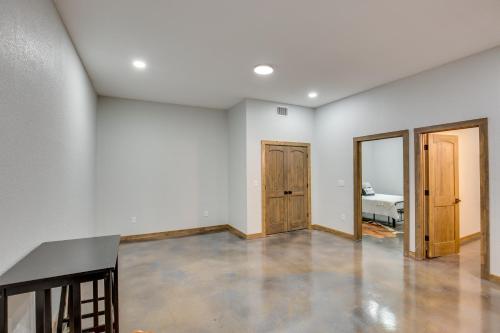 an empty room with white walls and wooden doors at Peaceful Yantis Retreat - 1 Mi to Lake Fork! in Yantis