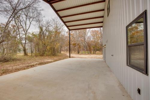 a walkway leading into a white building with a window at Peaceful Yantis Retreat - 1 Mi to Lake Fork! in Yantis