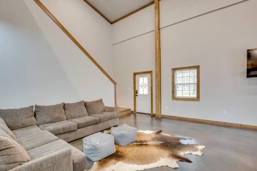 a living room with a couch and a rug at Serene Yantis Getaway - 1 Mi to Lake Fork! in Yantis