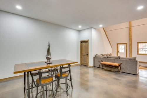 a living room with a table and a couch at Serene Yantis Getaway - 1 Mi to Lake Fork! in Yantis