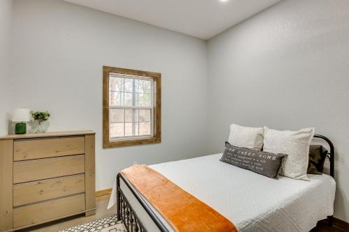 a bedroom with a bed and a dresser and a window at Serene Yantis Getaway - 1 Mi to Lake Fork! in Yantis