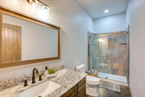 a bathroom with a sink and a toilet and a mirror at Serene Yantis Getaway - 1 Mi to Lake Fork! in Yantis