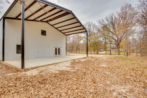 a large white building with a large amount of leaves at Serene Yantis Getaway - 1 Mi to Lake Fork! in Yantis
