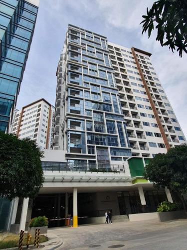 a large building with people standing in front of it at Mactan Newtown Beach Condo in Mactan