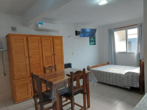 a dining room with a table and a bed at Apartamentos David in Ostende