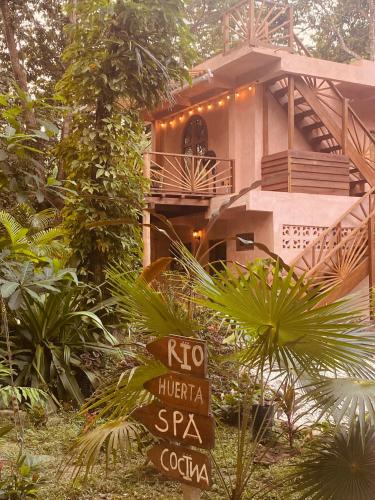 a house with a sign in front of it at Salvia Madre Hotel Boutique in Guachaca
