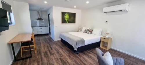 a bedroom with a bed and a desk and a table at Mt Field Retreat in National Park