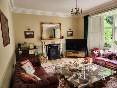 a living room with a couch and a fireplace at Mulgrave Country Cottage in Whitby